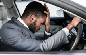 Stressed businessman feeling headache in car, stop the car